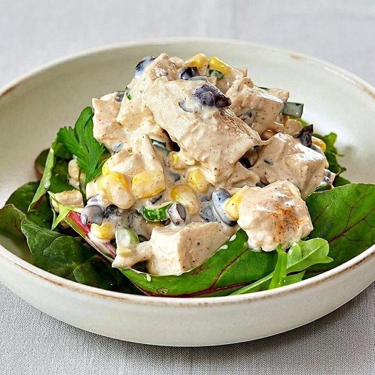 Chicken salad plate on a bed of greens