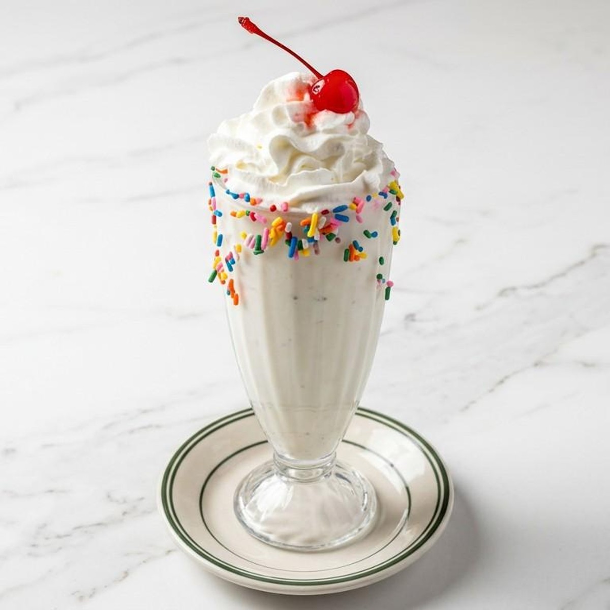 Chocolate milkshake with whipped cream and a cherry