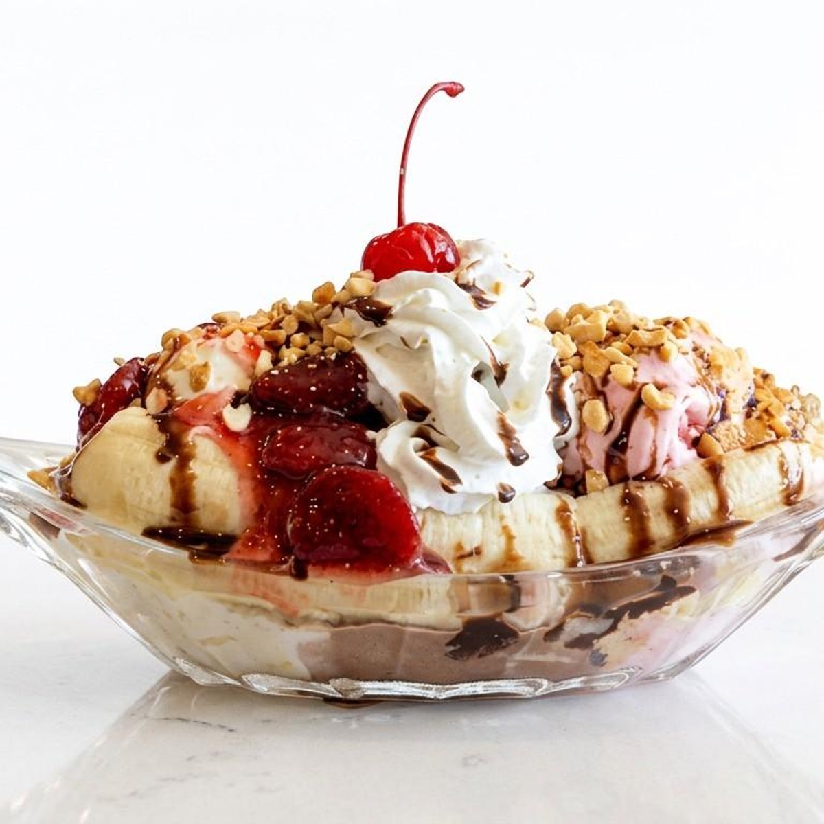 Classic banana split with whipped cream and cherries