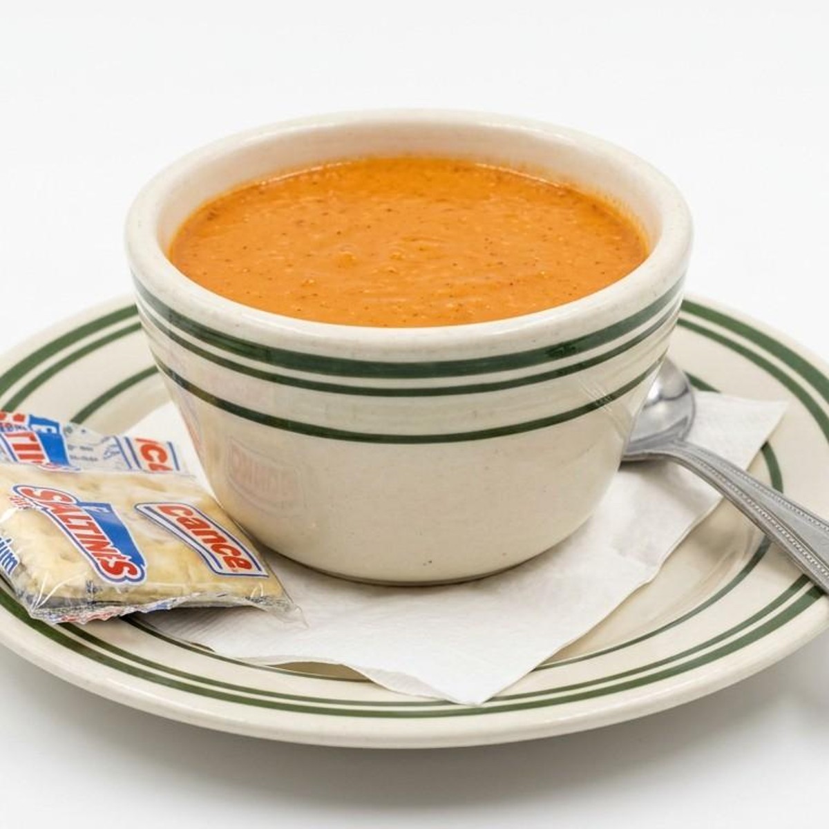 Bowl of tomato soup with saltine crackers