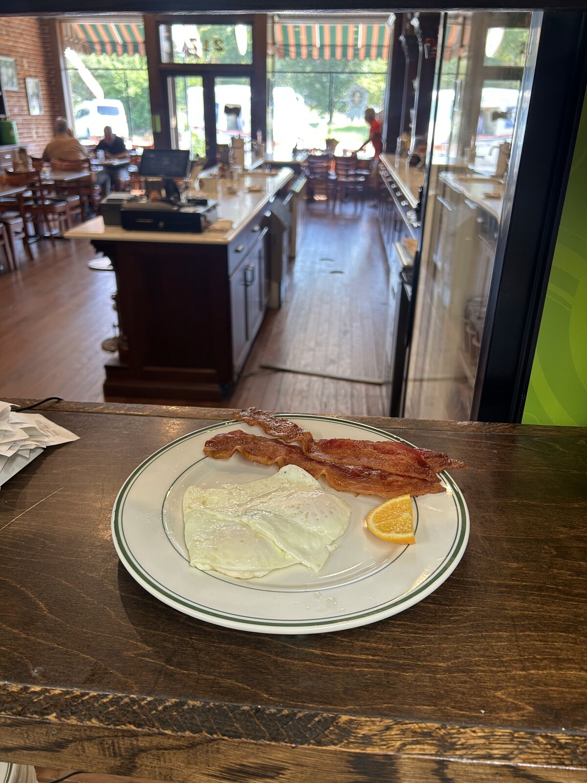 Egg plate with bacon and an orange slice