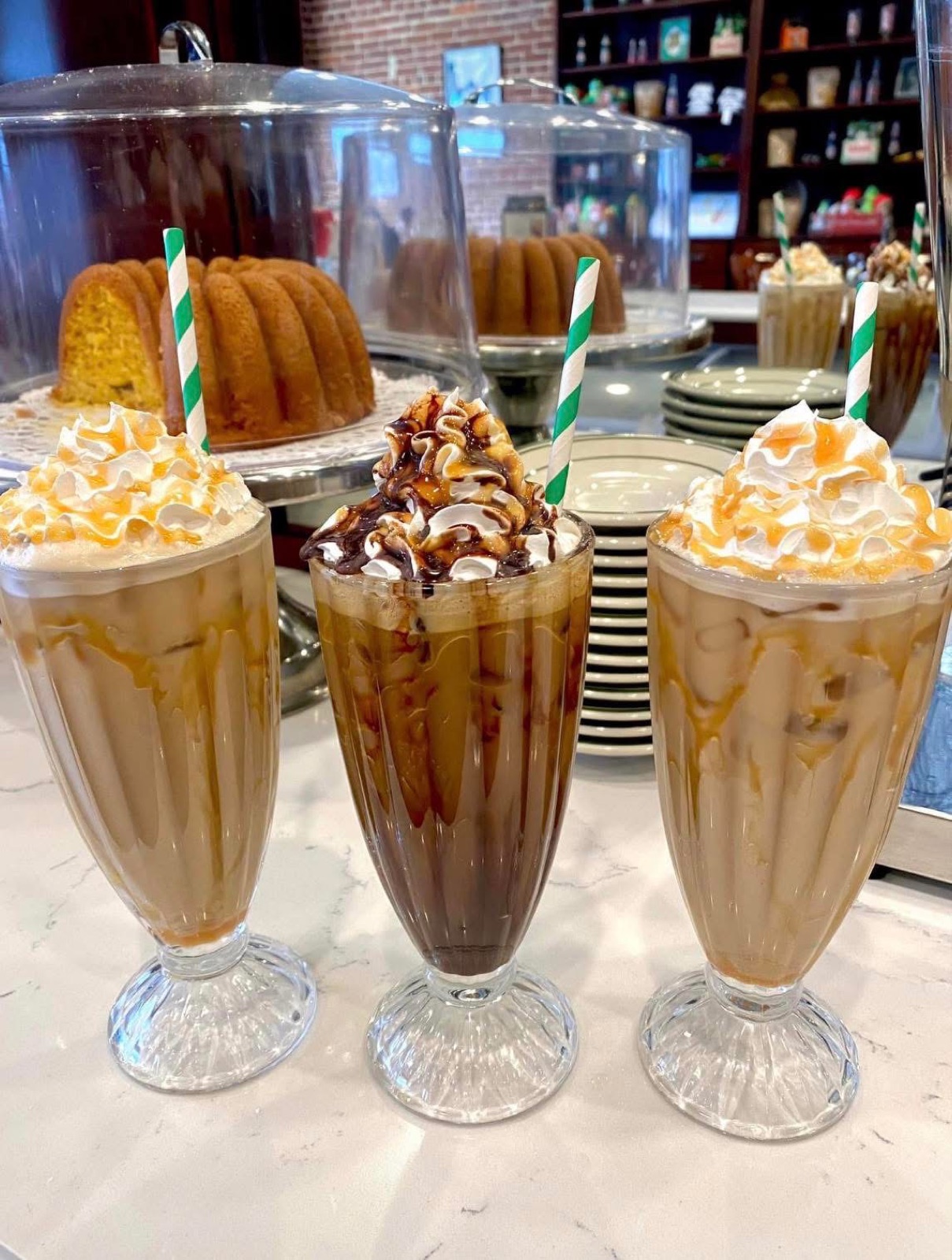 Three hand-spun milkshakes with whipped cream and cherries