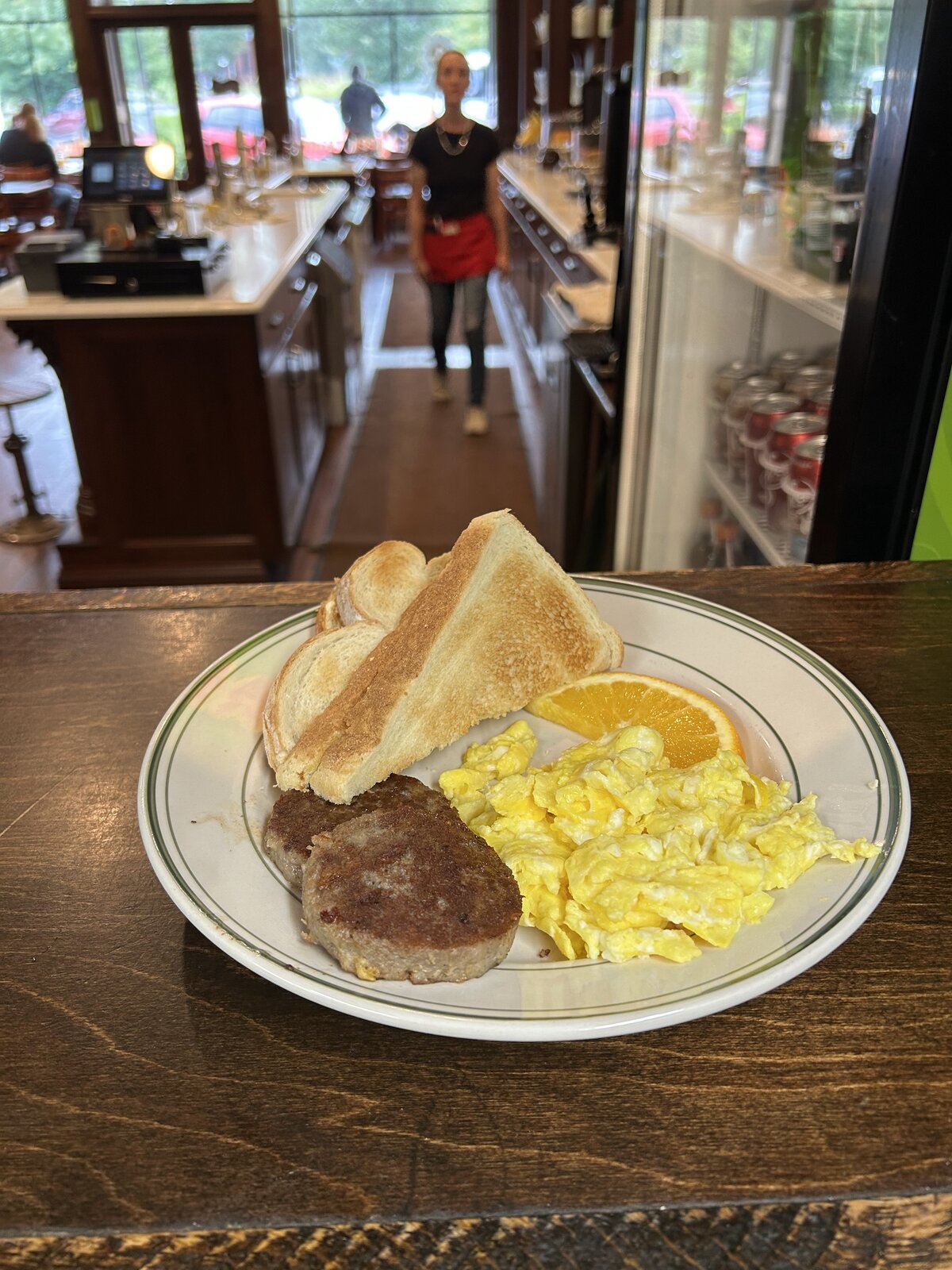 Queen City breakfast platter with toast and orange slice on the counter